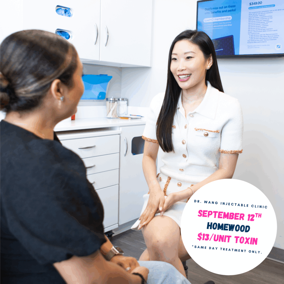 A woman provider smiling while consulting a patient in a bright dermatology and injectables clinic