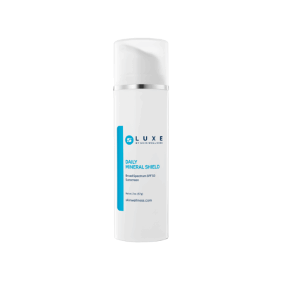 White pump bottle of LUXE Daily Mineral Shield broad-spectrum SPF 50 sunscreen for daily facial protection