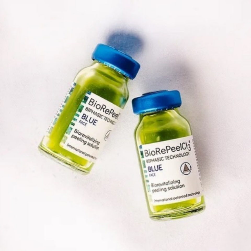 Two BioRePeel Blue vials with green solution and blue caps – biorevitalizing peeling solution for skincare treatments.