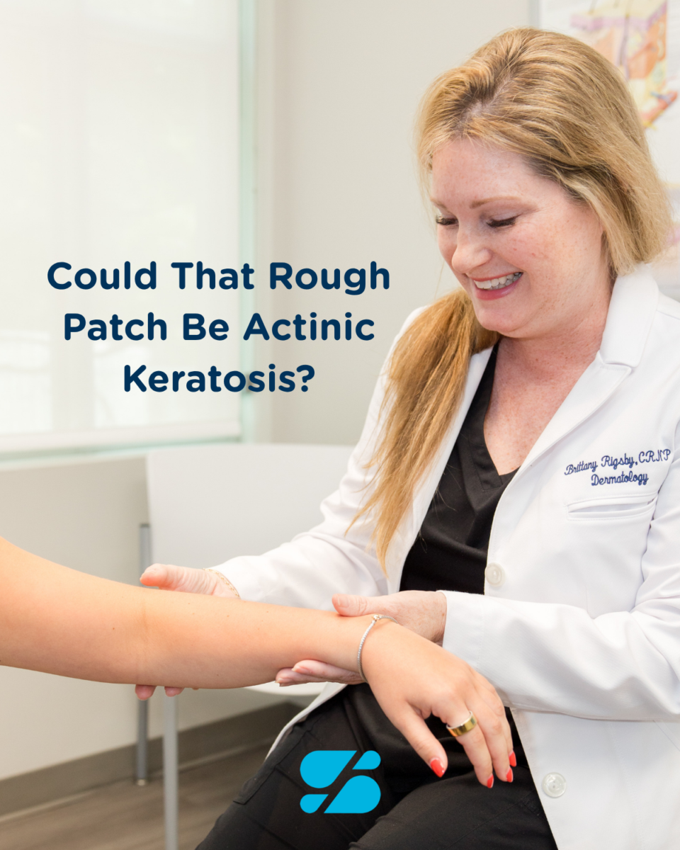 a dermatologist examining a patient's forearm for actinic keratosis during a skin check in Birmingham, AL.