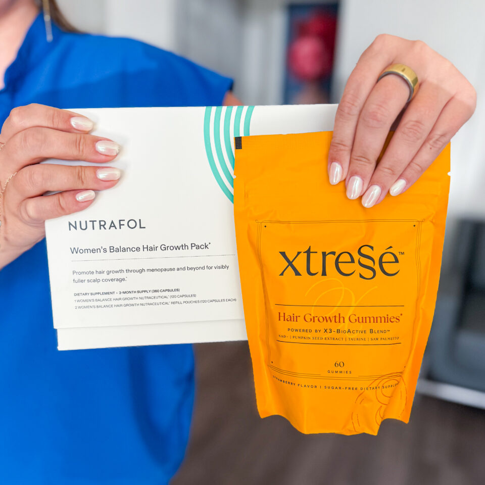A woman holding Nutrafol box and xtreSe hair growth gummies pack