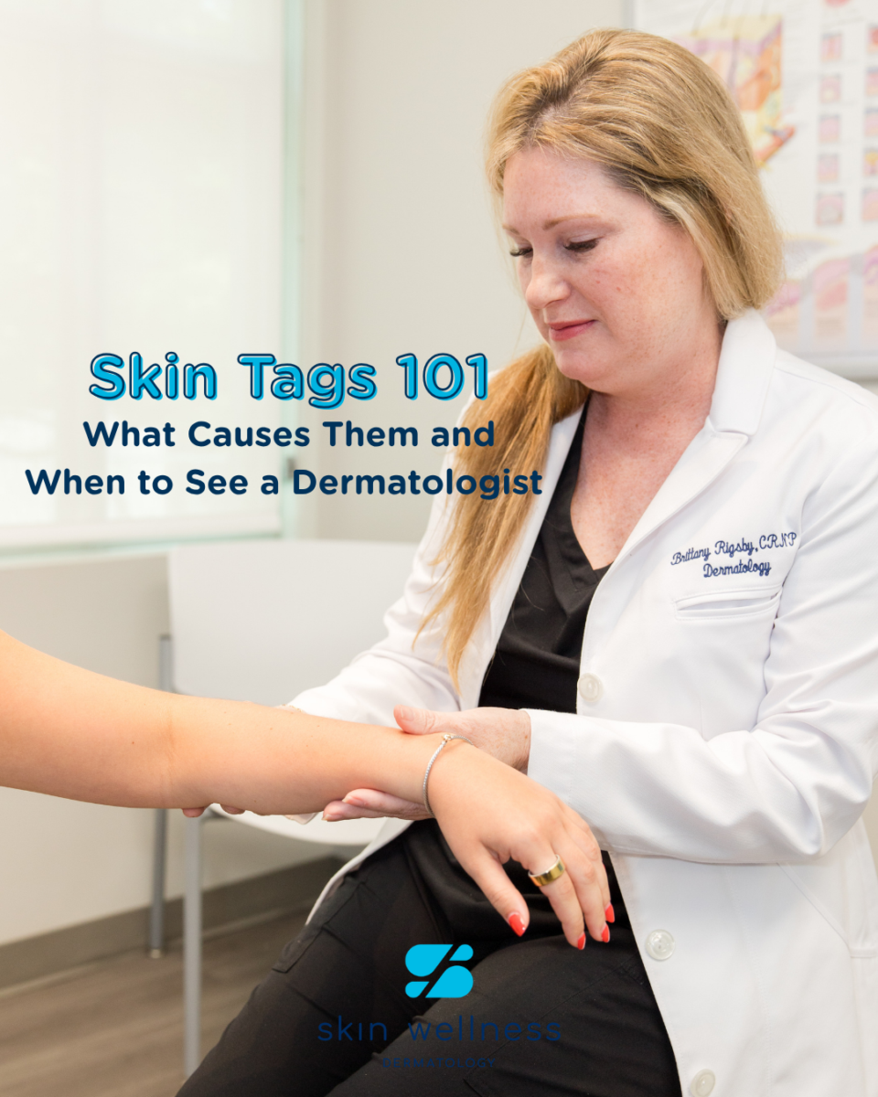 A dermatologist examining a patient's arm in a Birmingham clinic with 'Skin Tags 101' text and Skin Wellness logo.